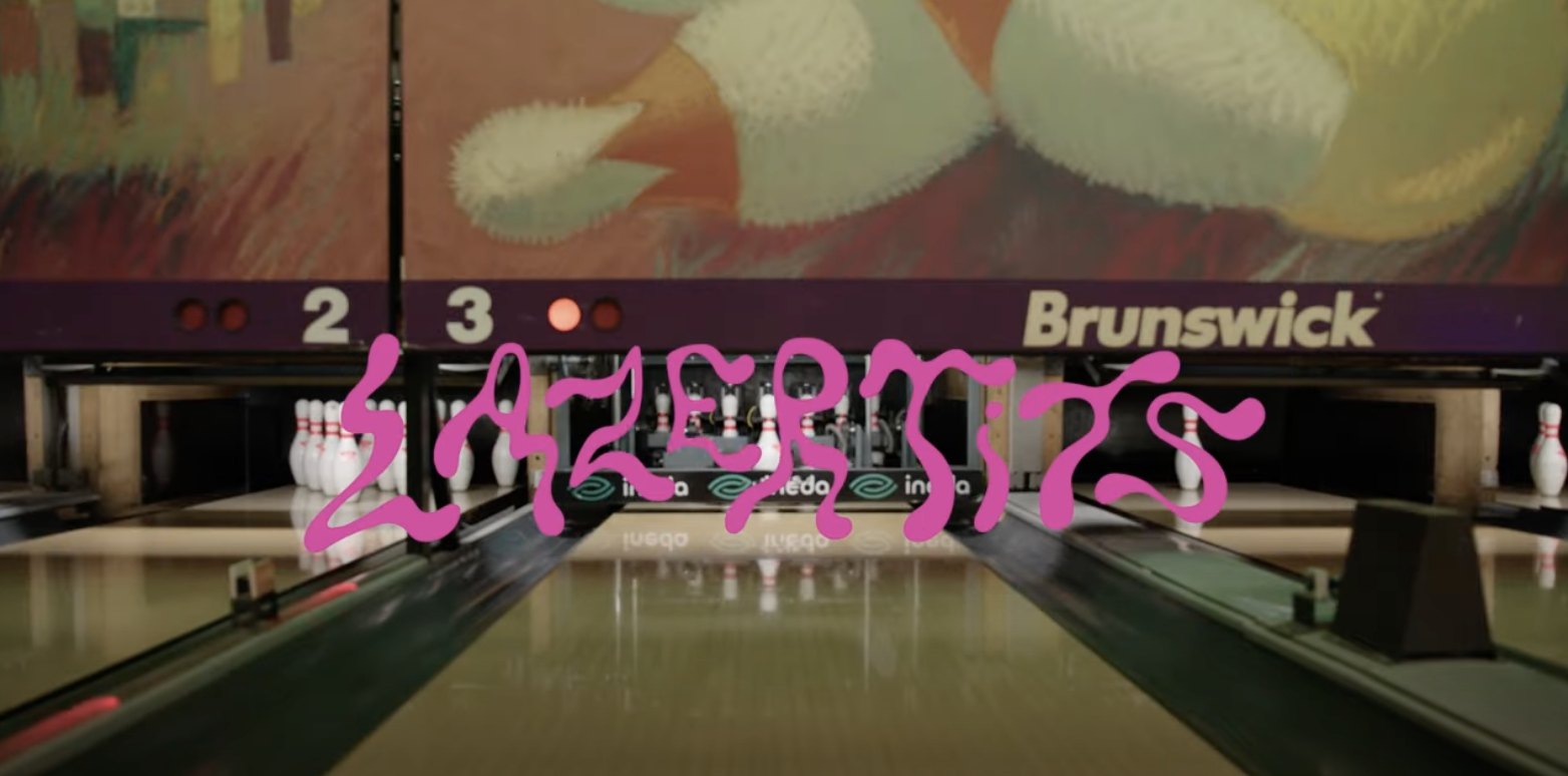 The lazertits logo in a bowling alley
