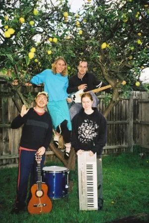 The band in front of a lemon tree.